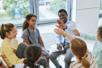 A group of teens in a therapy session.