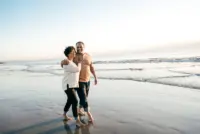 A couple walking down the beach,