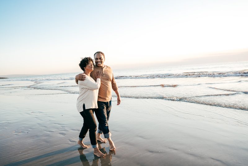 A couple walking down the beach,