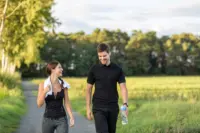 Two people walking on a trail.
