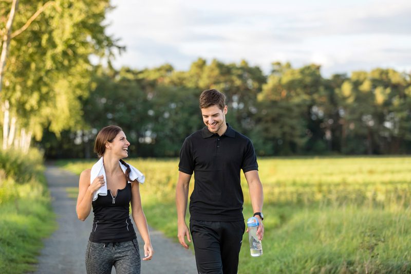 Two people walking on a trail.